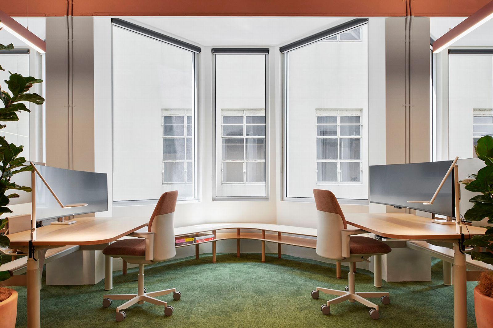 two workspaces wit humanscale path chair next to window