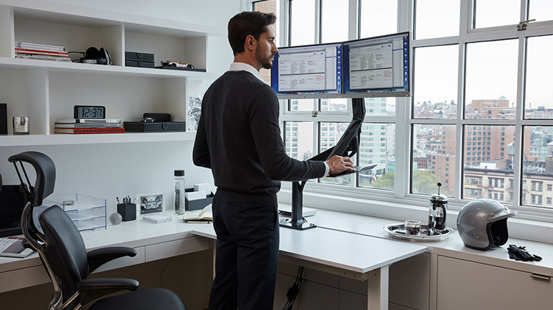 Man standing at a standing desk