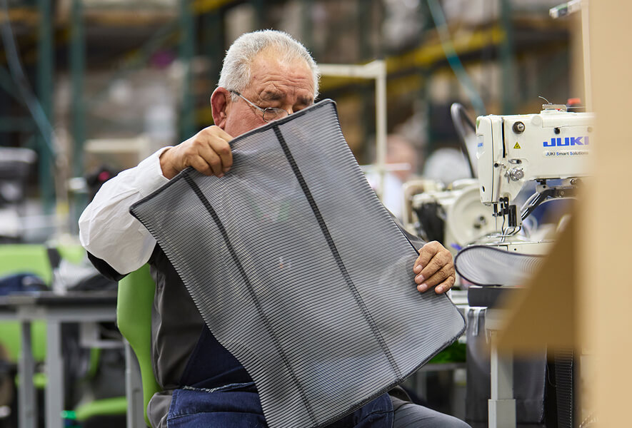 industrial worker handling chair mesh